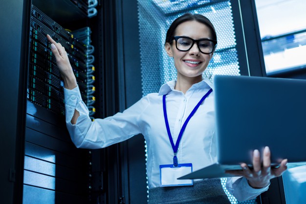 my-best-day-content-attractive-woman-working-server-cabinet-holding-her-laptop_259150-2967